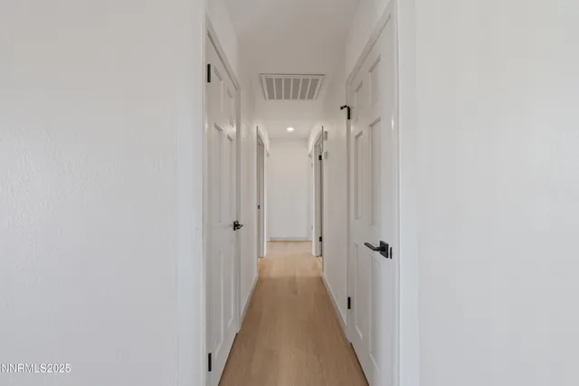 a view of an empty room with painting on the wall