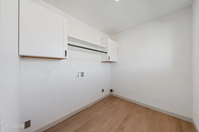 a big house with large tree in front of it