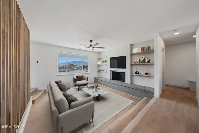 an empty room with a fireplace and window