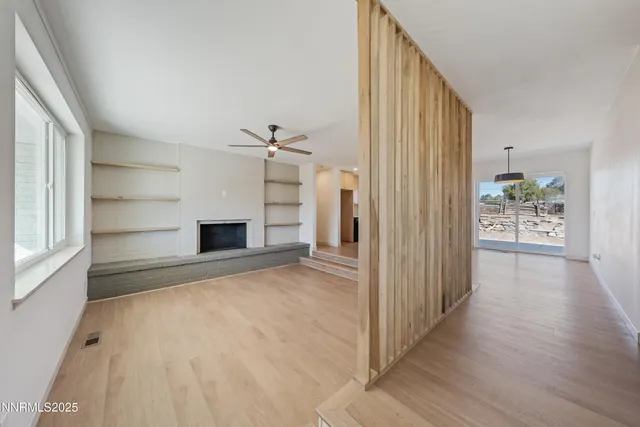 a view of room with ceiling fan and window