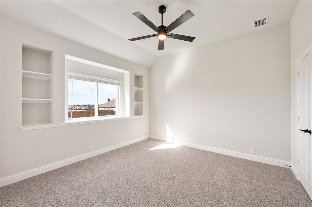 12605 Rocky Top Road Godley, TX 76044 - Photo 11 of 40 an empty room with a window and a fan