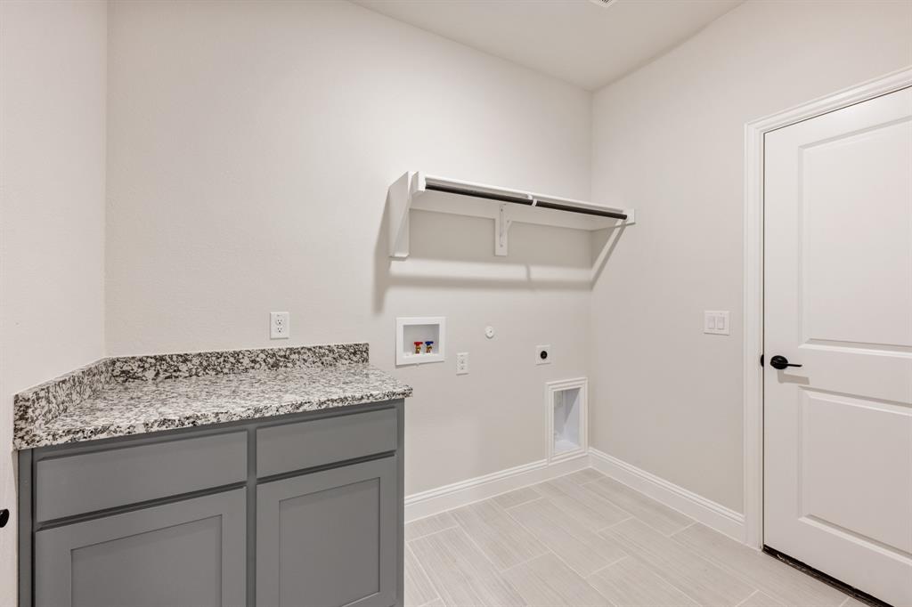 12605 Rocky Top Road Godley, TX 76044 - Photo 14 of 40 a bathroom with a granite countertop sink and white cabinets