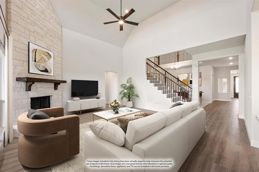 12605 Rocky Top Road Godley, TX 76044 - Photo 15 of 40 a living room with furniture a flat screen tv and a fireplace
