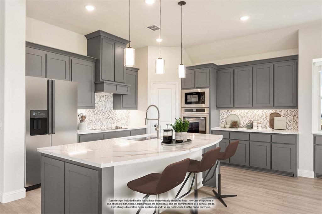 12605 Rocky Top Road Godley, TX 76044 - Photo 18 of 40 a kitchen with stainless steel appliances granite countertop a sink a stove a refrigerator and island with wooden floor