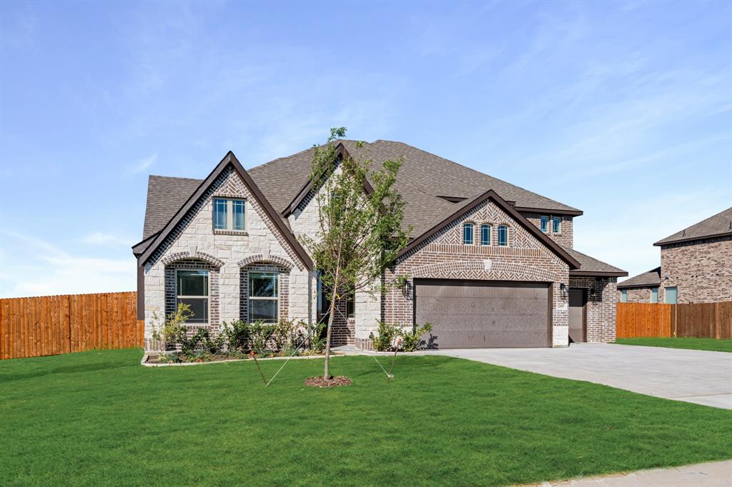 12605 Rocky Top Road Godley, TX 76044 - Photo 2 of 40 a front view of a house with a garden
