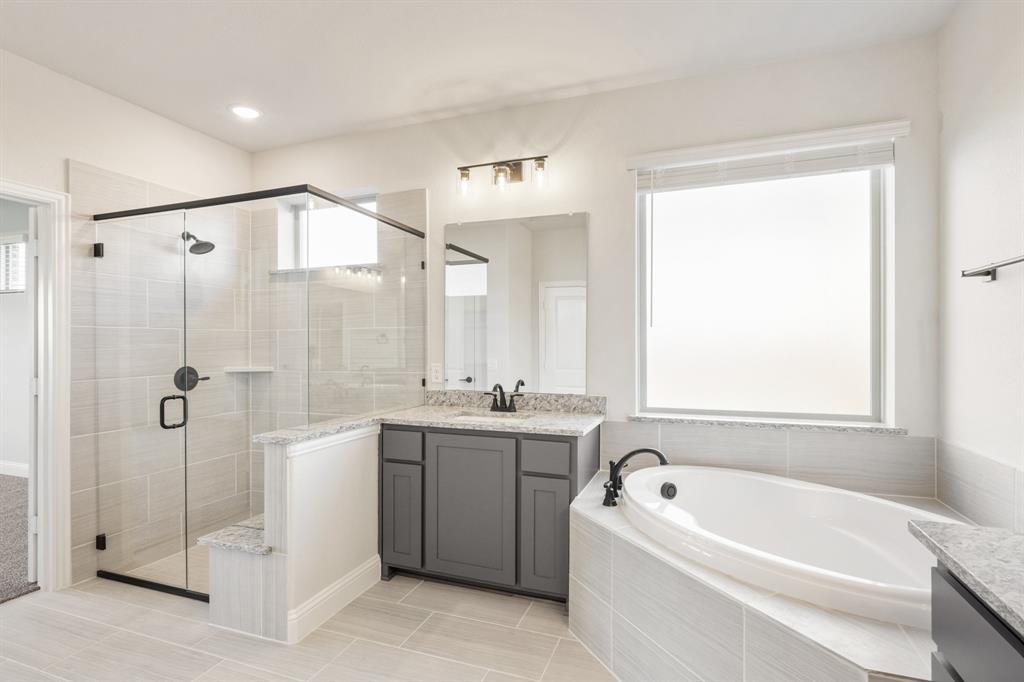 12605 Rocky Top Road Godley, TX 76044 - Photo 26 of 40 a bathroom with a tub sink and mirror
