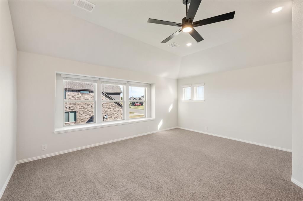 12605 Rocky Top Road Godley, TX 76044 - Photo 29 of 40 an empty room with windows and ceiling fan