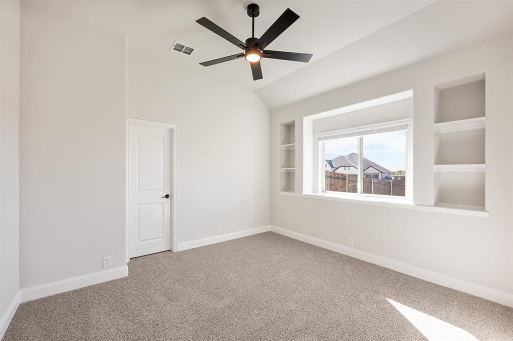 12605 Rocky Top Road Godley, TX 76044 - Photo 10 of 40 an empty room with a window and a fan