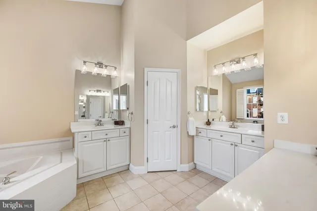 a large bathroom with a double vanity sink a mirror and a shower