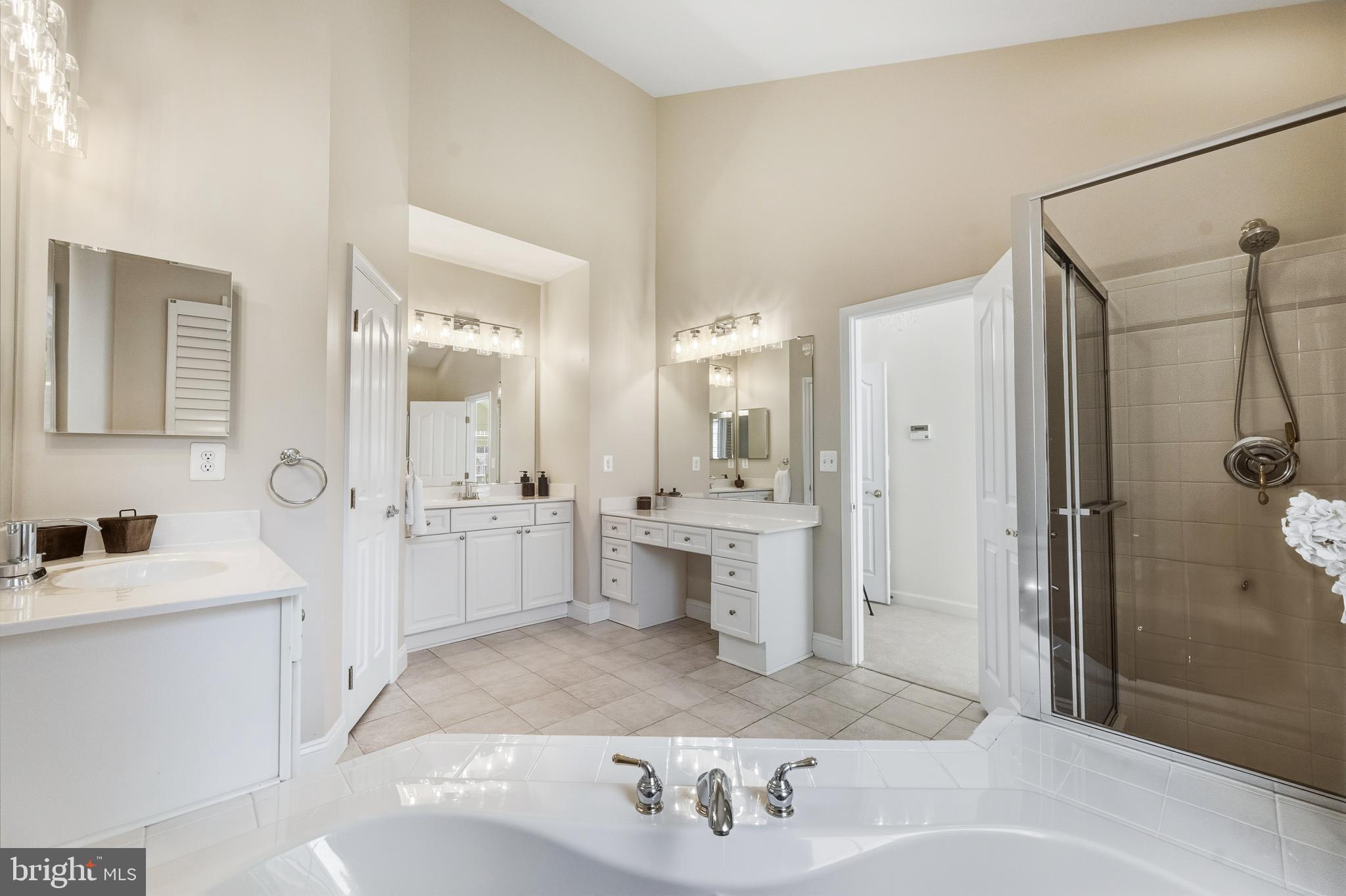 1919 Logan Manor Drive Reston, VA 20190 - Photo 17 of 57 a large bathroom with a double vanity sink a mirror and a shower