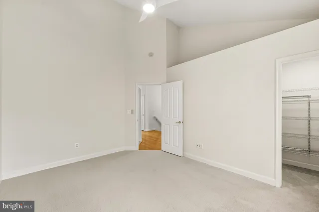 a bathroom with a double vanity sink a toilet and a large mirror