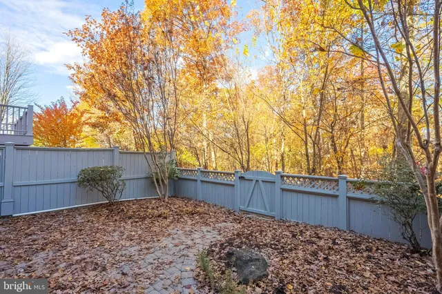 a view of a roof deck with wooden fence and floor