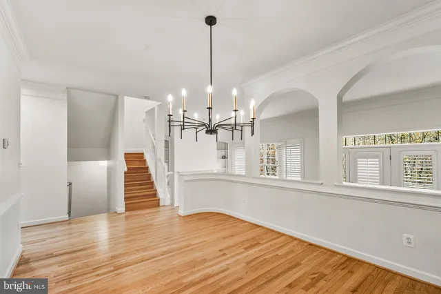a view of a room with wooden floor and staircase
