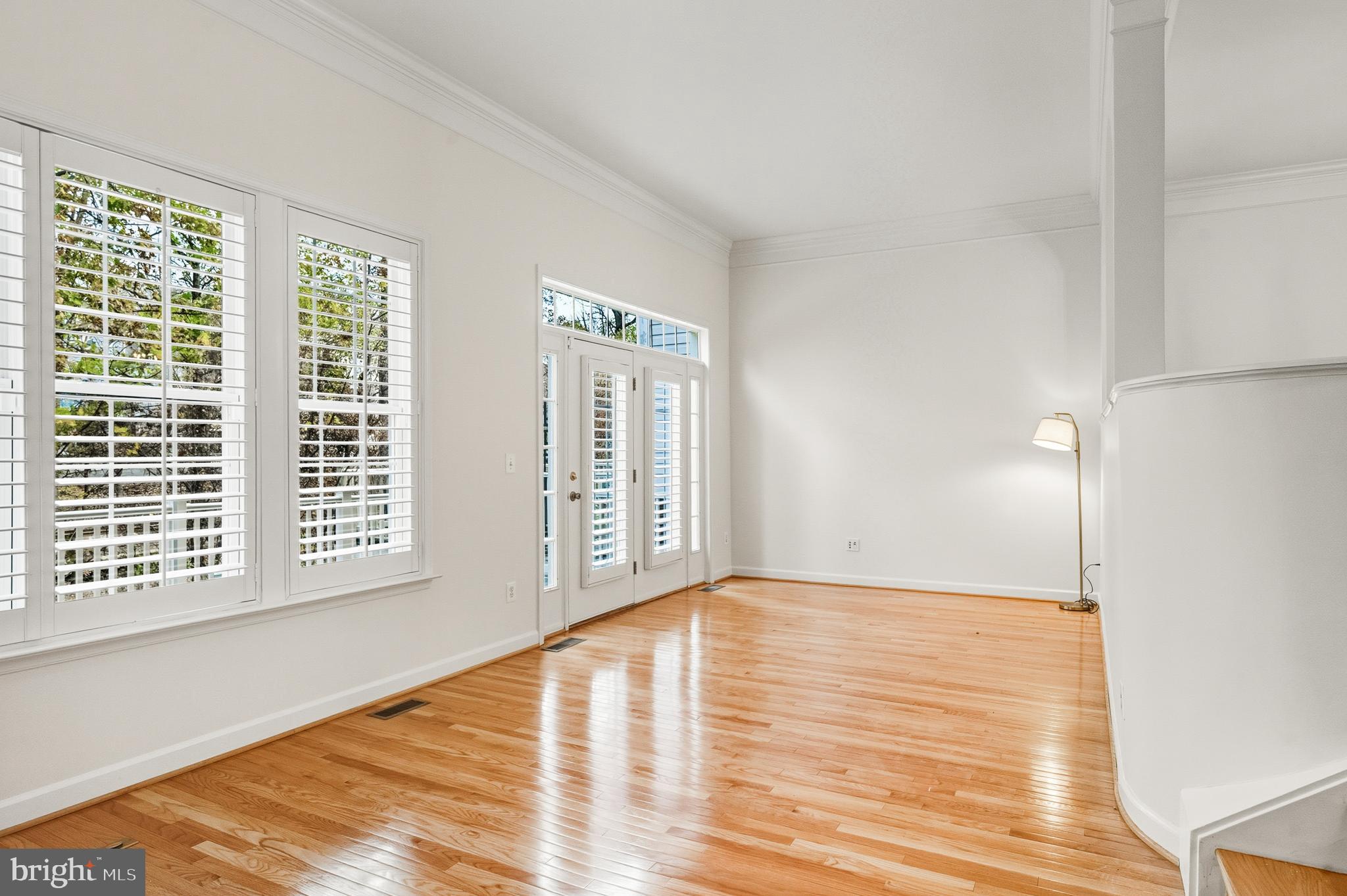 1919 Logan Manor Drive Reston, VA 20190 - Photo 7 of 57 a view of an empty room with wooden floor and a window