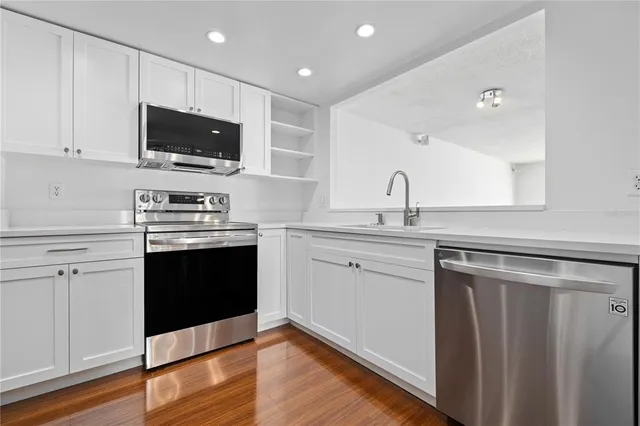 a kitchen with a sink stove and microwave