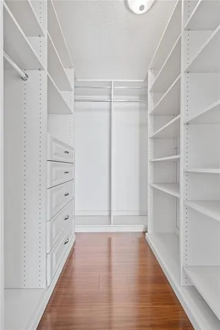 a view of walk in closet with empty racks