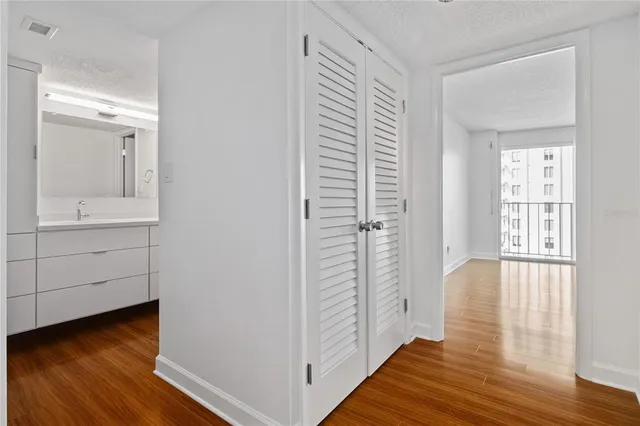 a view of a room with wooden floor and cabinet