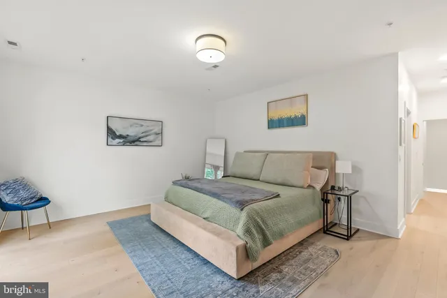 a bedroom with a bed and a lamp