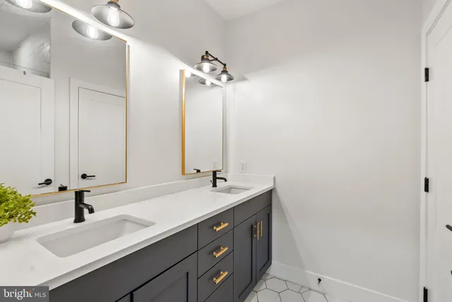 a bathroom with a sink vanity granite and a mirror
