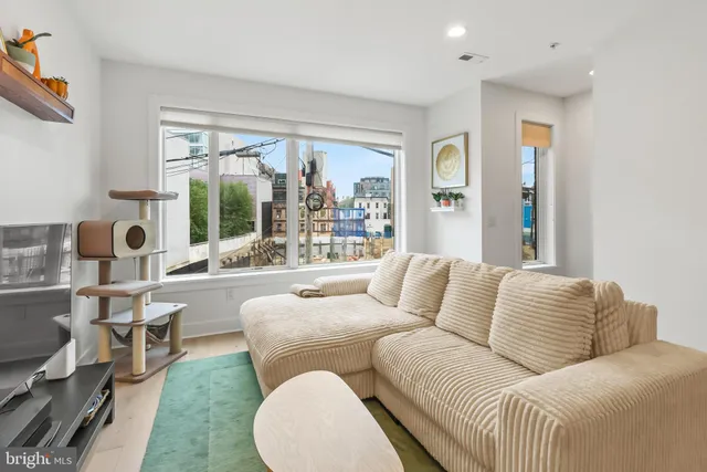 a living room with furniture and large windows