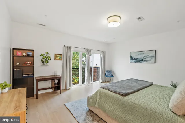 a bedroom with a bed and a large window