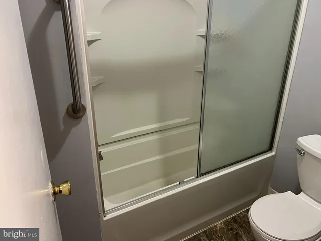a bathroom with a toilet and a shower