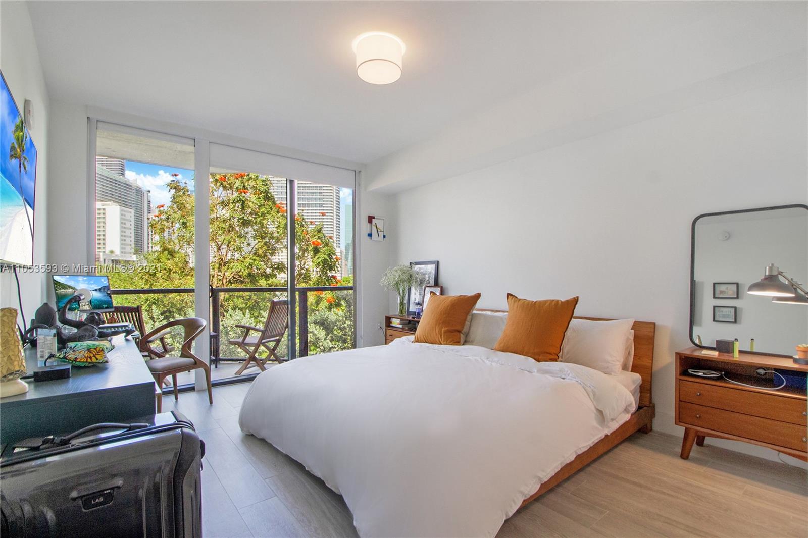 201 Southwest 17th Road, Unit 511 Miami, FL 33129 - Photo 11 of 16 a bedroom with a balcony a bed and a couch