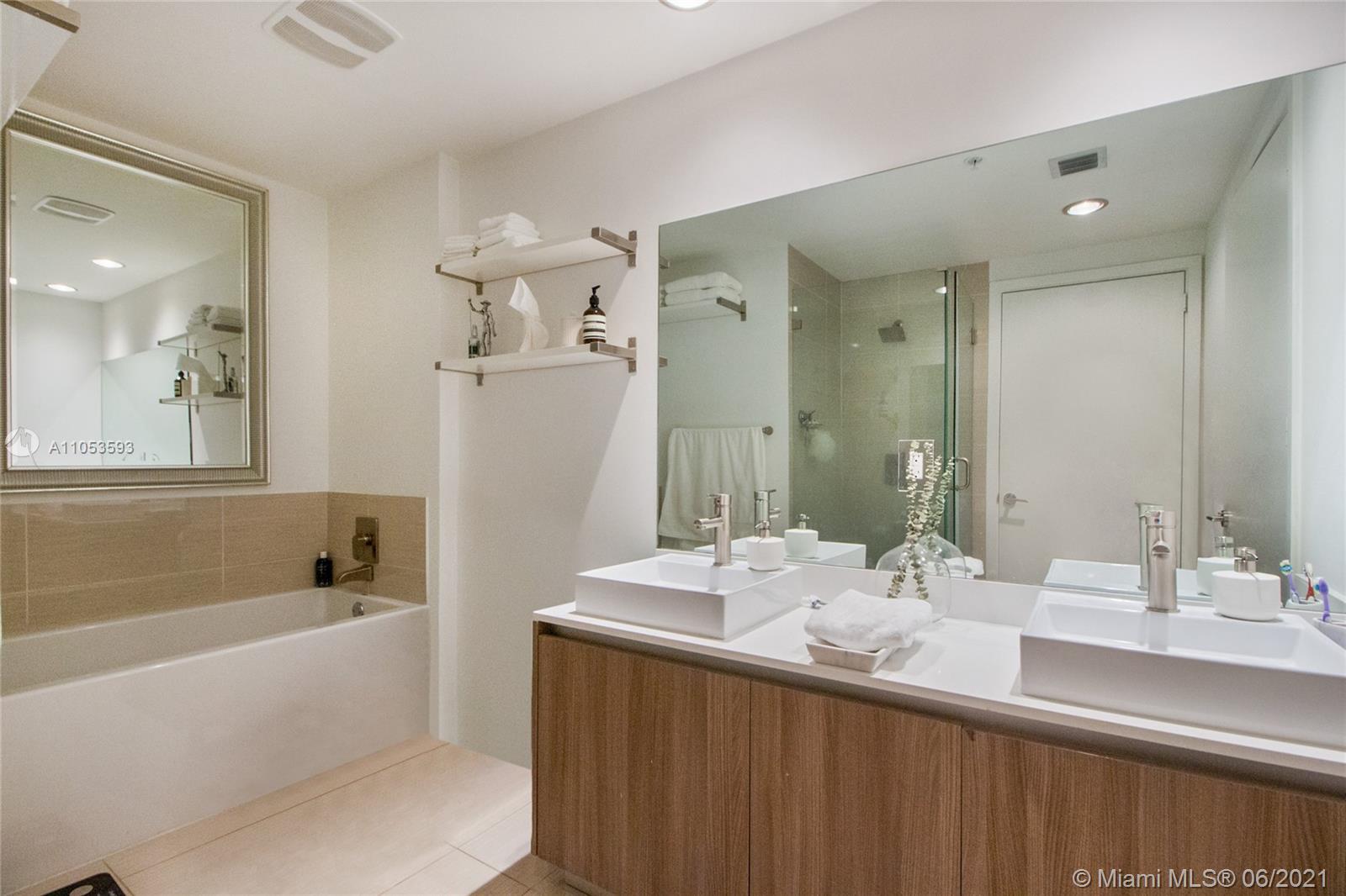 201 Southwest 17th Road, Unit 511 Miami, FL 33129 - Photo 13 of 16 a bathroom with a tub a sink and mirror