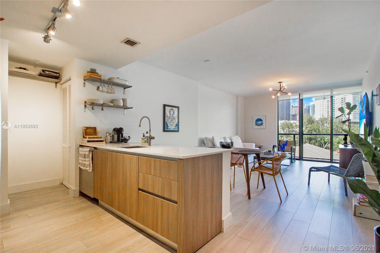 201 Southwest 17th Road, Unit 511 Miami, FL 33129 - Photo 3 of 16 a view of a dining room with furniture window and wooden floor