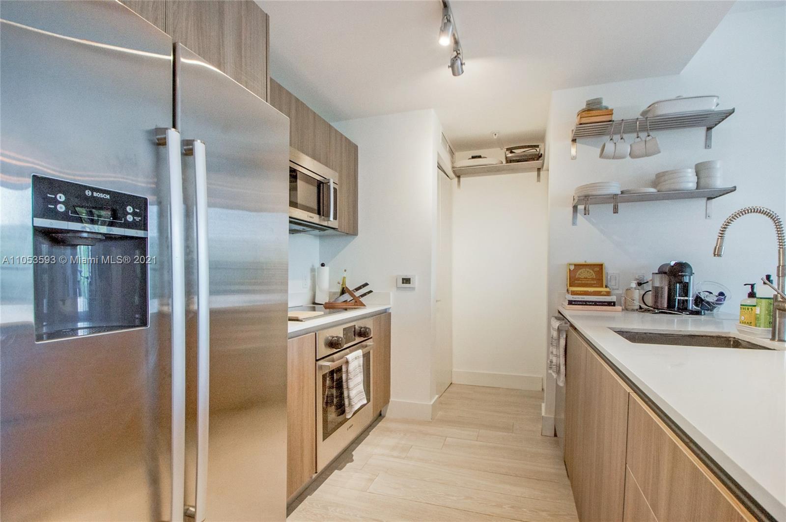 201 Southwest 17th Road, Unit 511 Miami, FL 33129 - Photo 4 of 16 a kitchen with stainless steel appliances granite countertop a refrigerator and a sink