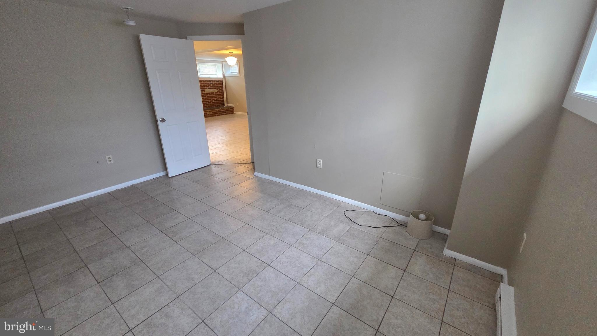 4400 4th Street Baltimore, MD 21225 - Photo 16 of 25 an empty room with entrance and mirror