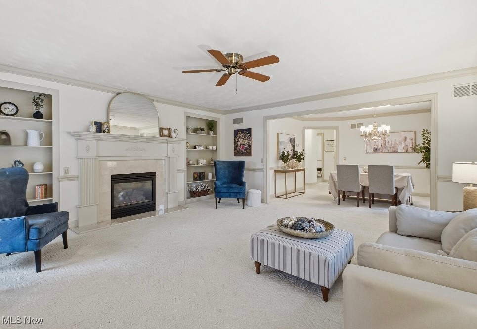197 Mathews Road, Unit B Youngstown, OH 44512 - Photo 3 of 37 Living room featuring a premium fireplace, ornamental molding, a ceiling fan, carpet flooring, and built in shelves
