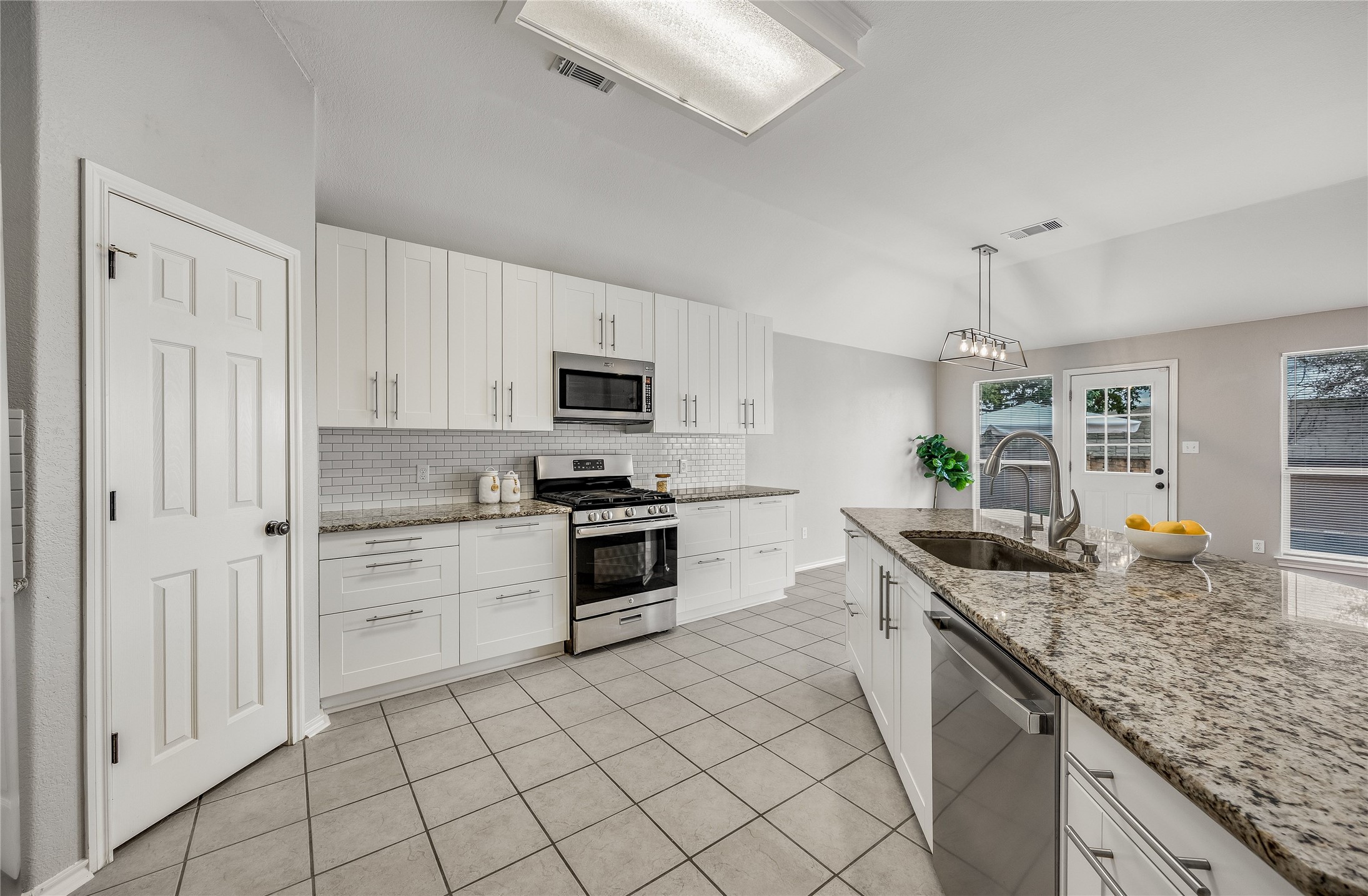 4319 South Summercrest Loop Round Rock, TX 78681 - Photo 14 of 35 a kitchen with granite countertop white cabinets and white appliances