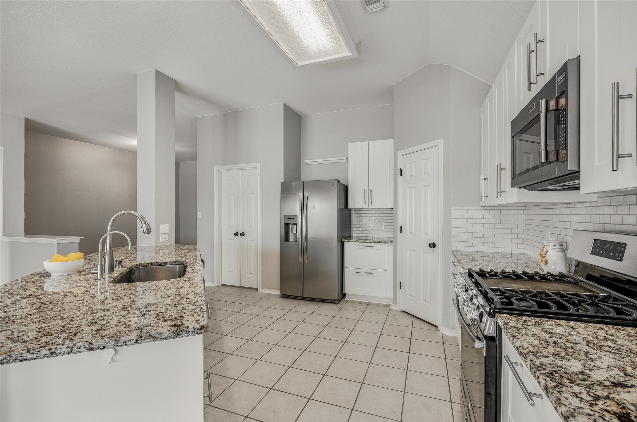 4319 South Summercrest Loop Round Rock, TX 78681 - Photo 15 of 35 a kitchen with stainless steel appliances granite countertop a sink stove and refrigerator