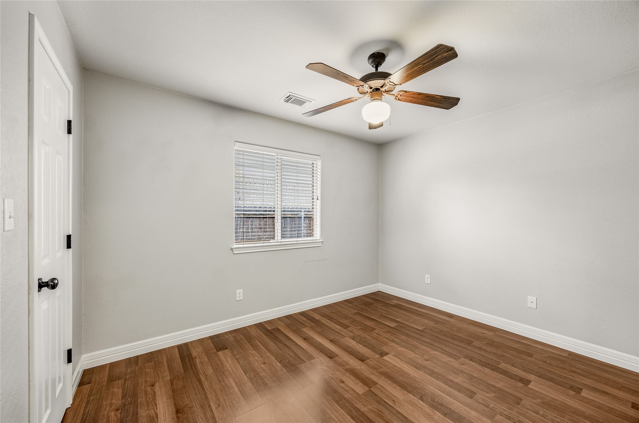 4319 South Summercrest Loop Round Rock, TX 78681 - Photo 20 of 35 an empty room with wooden floor fan and windows