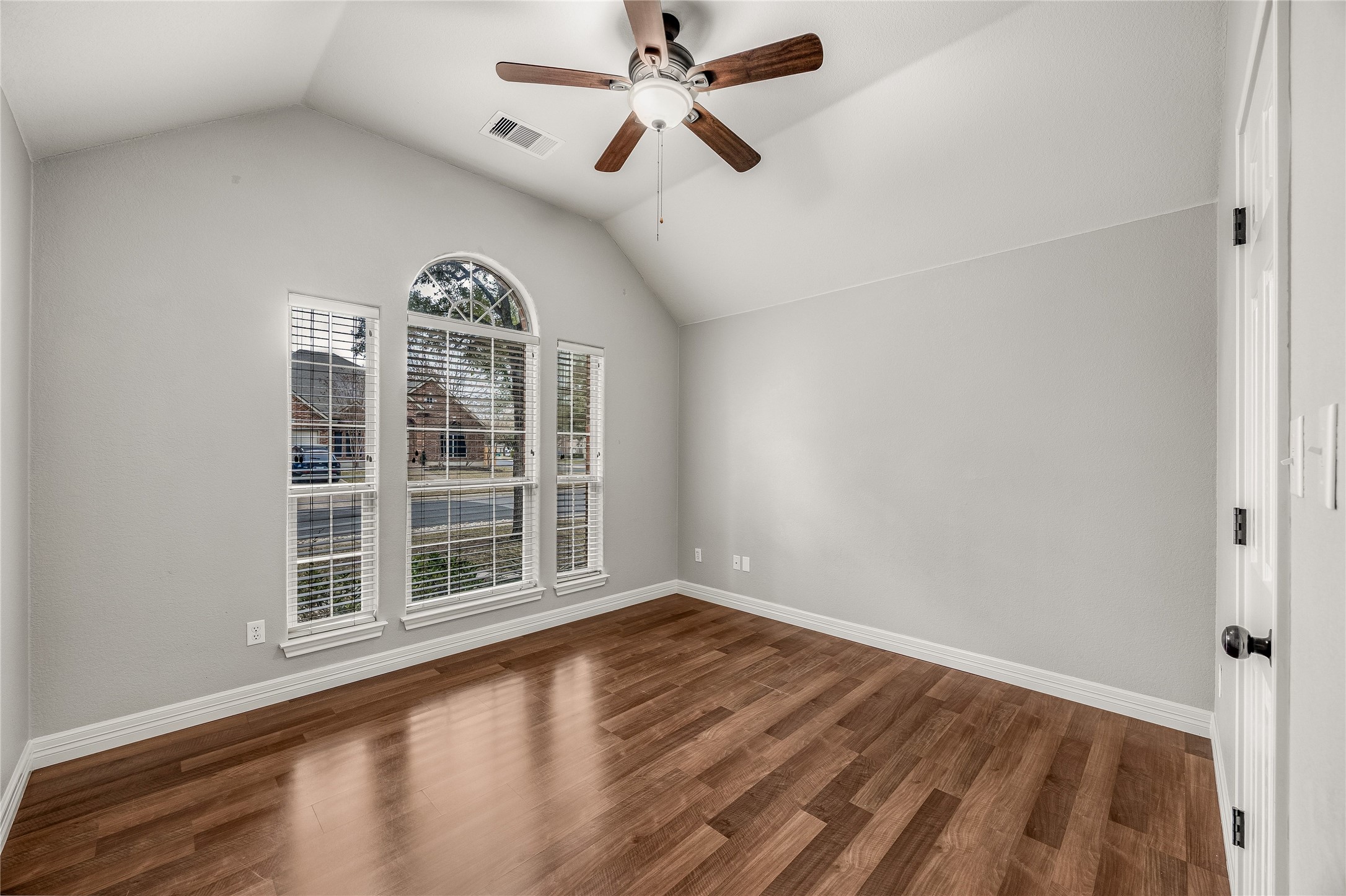 4319 South Summercrest Loop Round Rock, TX 78681 - Photo 22 of 35 an empty room with wooden floor ceiling fan and windows