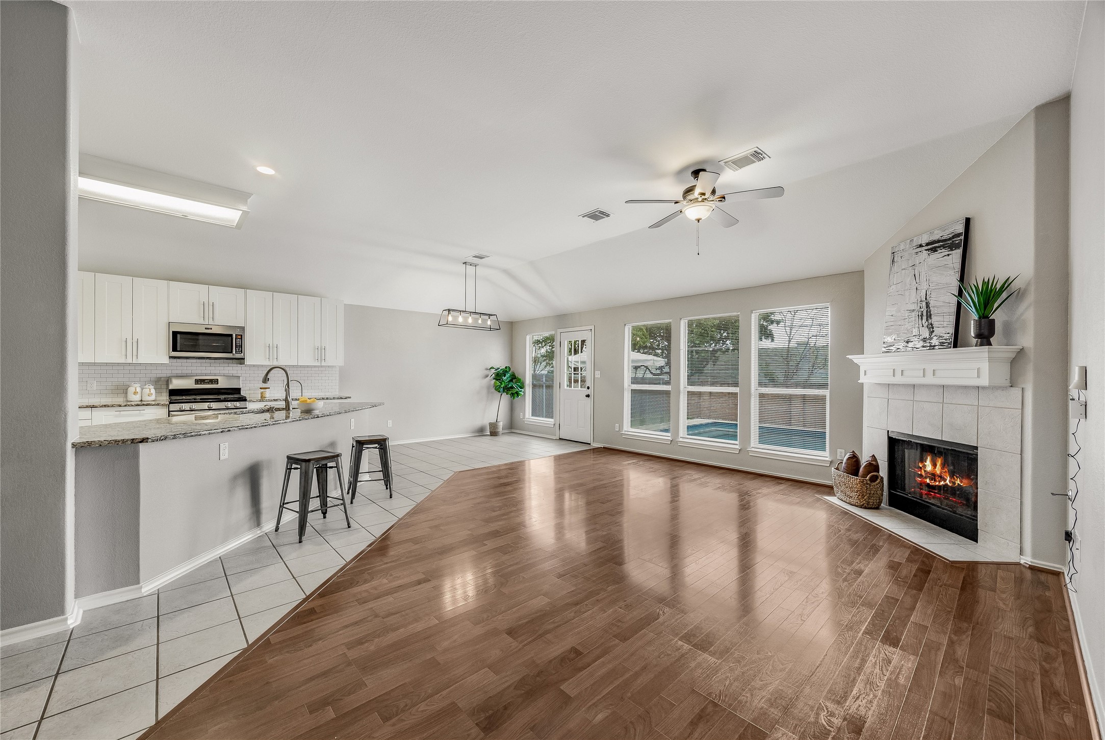 4319 South Summercrest Loop Round Rock, TX 78681 - Photo 10 of 35 a view of open kitchen with granite countertop a stove top oven a chimney cabinets and wooden floor