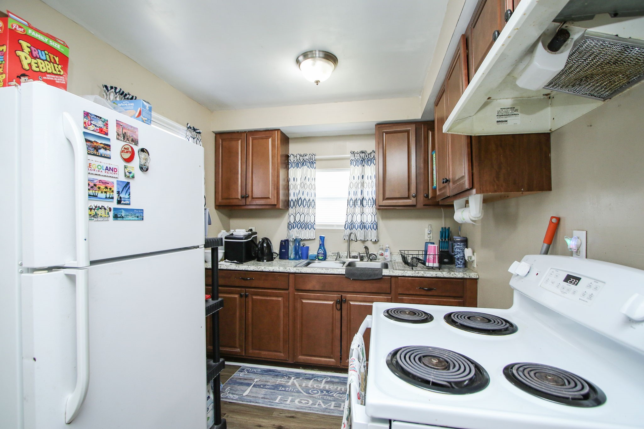 7610 Moore Road Pattison, TX 77423 - Photo 11 of 40 a kitchen with a refrigerator a stove and a sink