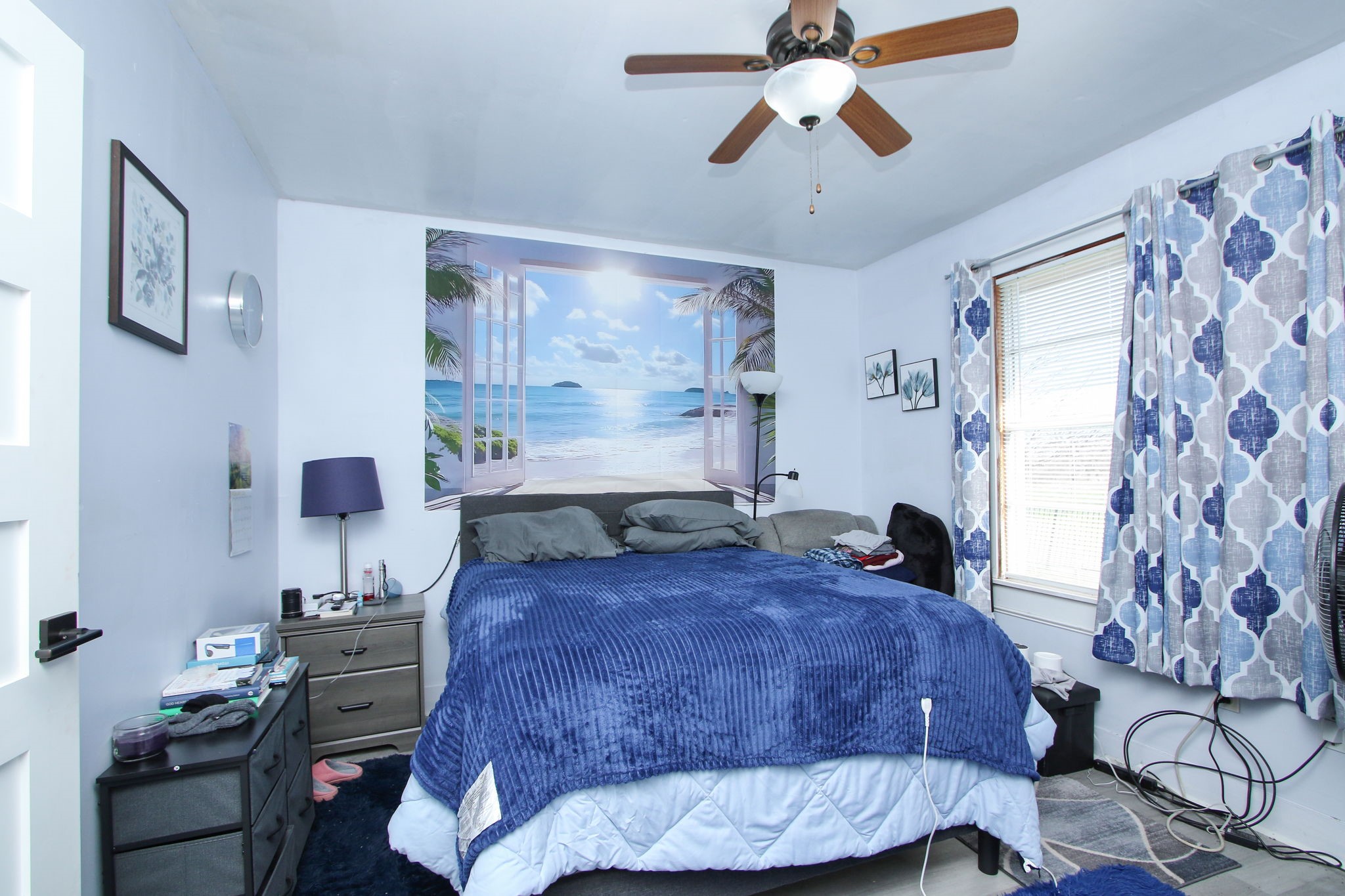 7610 Moore Road Pattison, TX 77423 - Photo 16 of 40 a bedroom with a bed and a chandelier