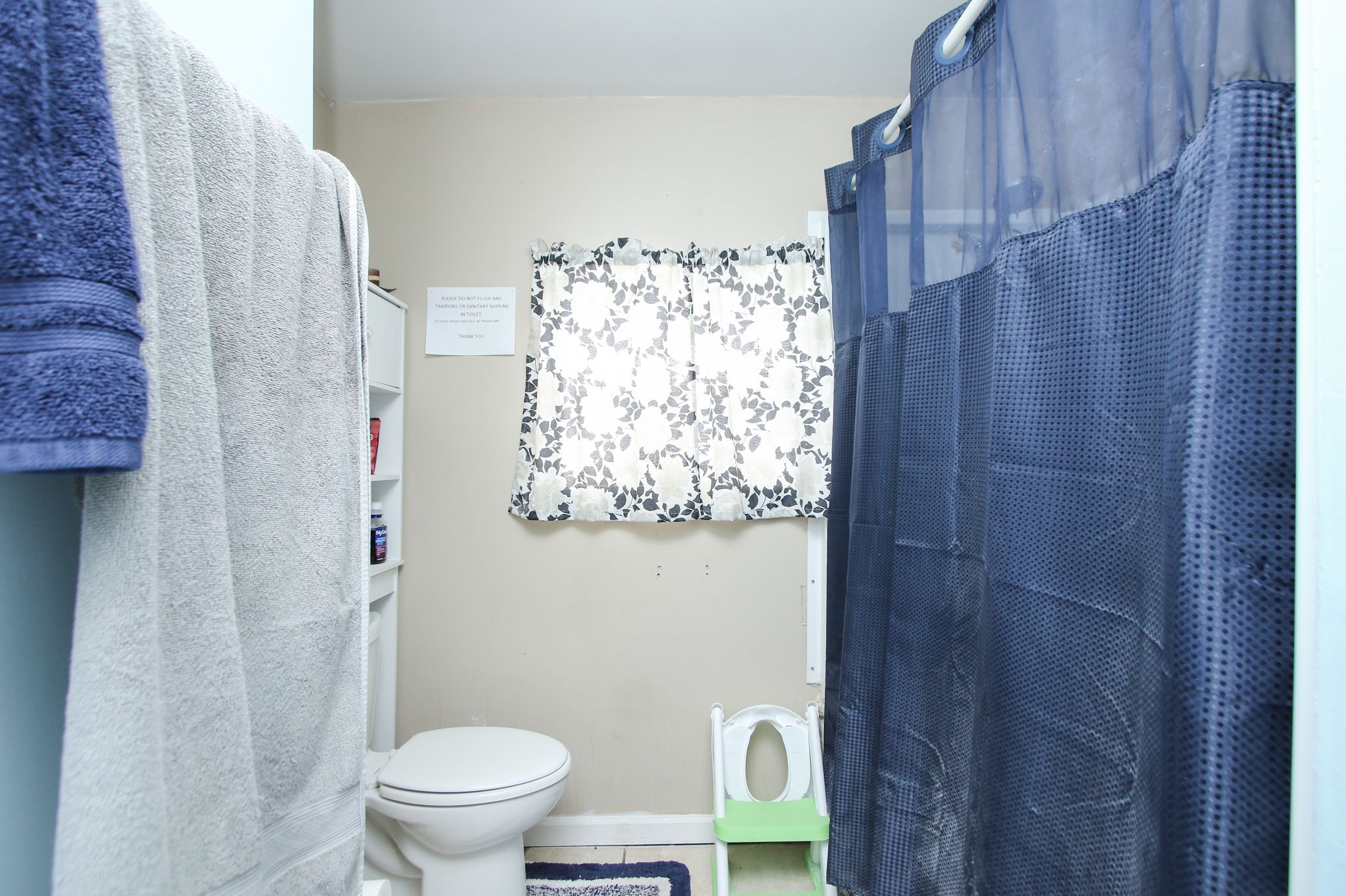 7610 Moore Road Pattison, TX 77423 - Photo 18 of 40 a white toilet sitting next to a shower curtain