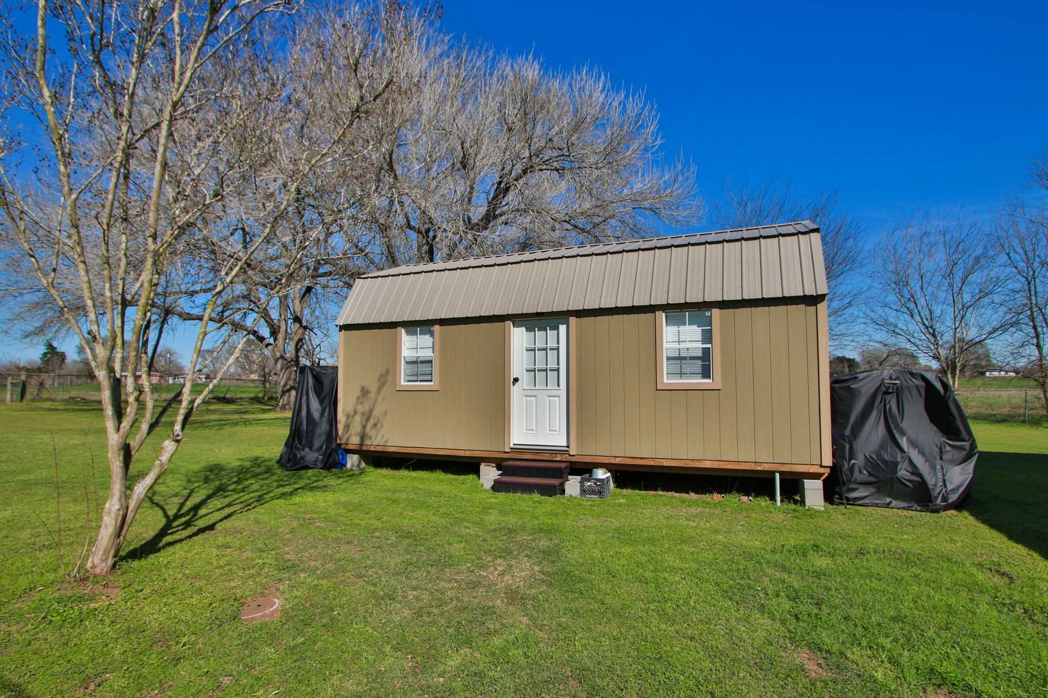 7610 Moore Road Pattison, TX 77423 - Photo 23 of 40 a view of backyard with large tree and wooden fence