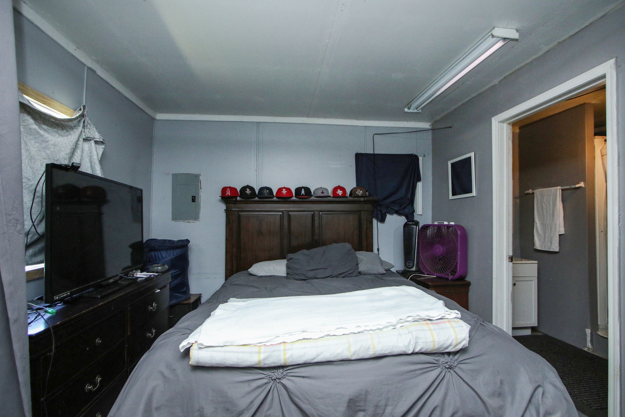 7610 Moore Road Pattison, TX 77423 - Photo 30 of 40 a bedroom with a bed and a flat screen tv