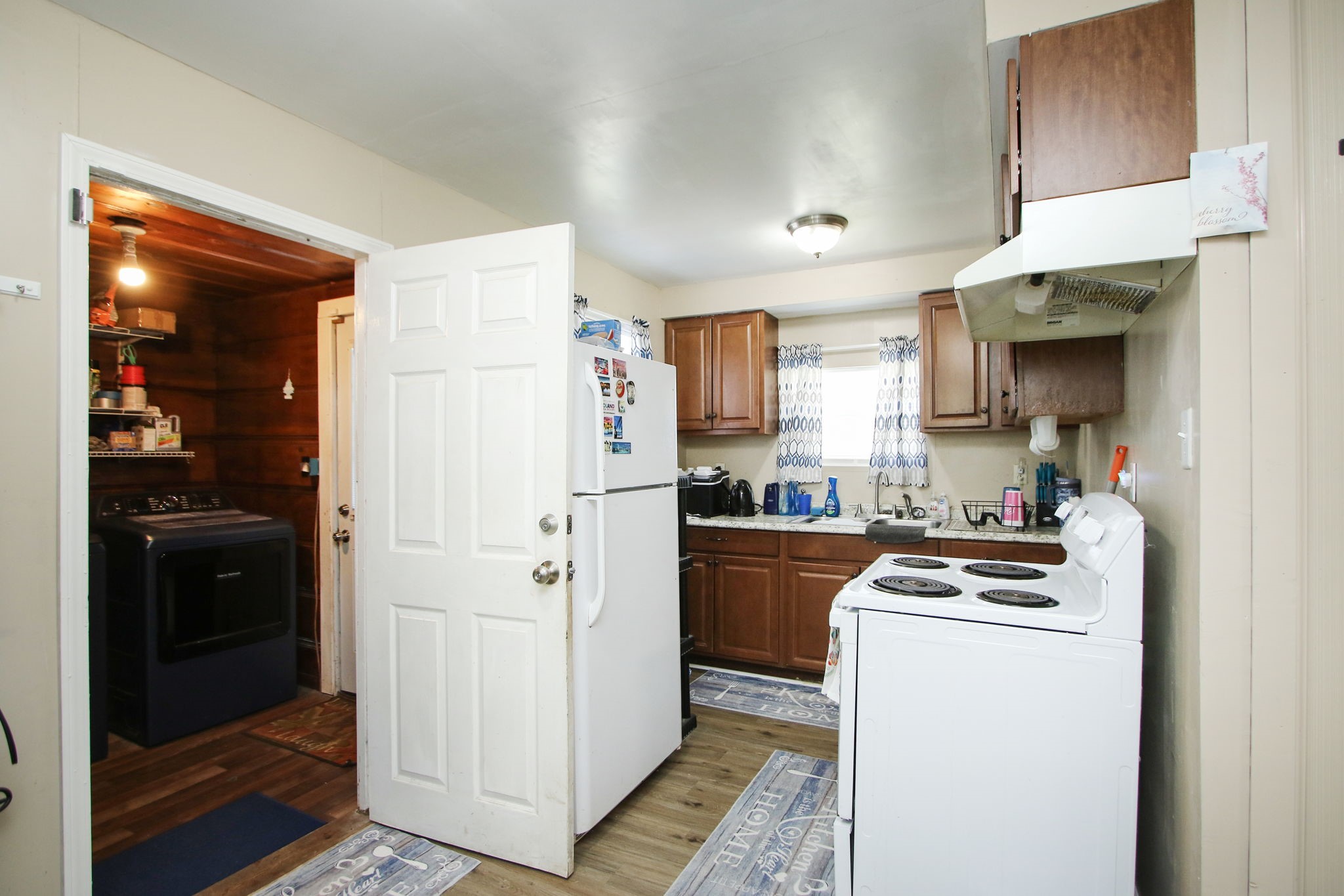 7610 Moore Road Pattison, TX 77423 - Photo 10 of 40 a kitchen with stainless steel appliances a refrigerator a stove and white cabinets