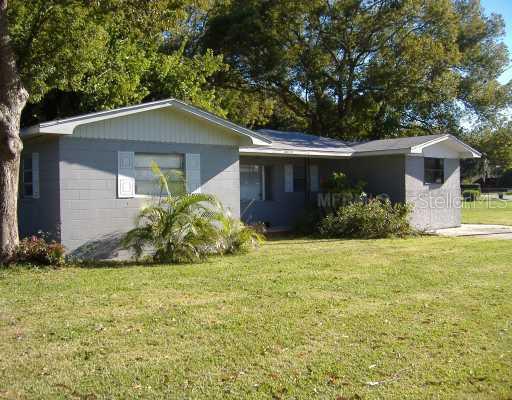 1035 North Combee Road Lakeland, FL 33801 - Photo 1 of 1 a front view of house with yard and trees all around