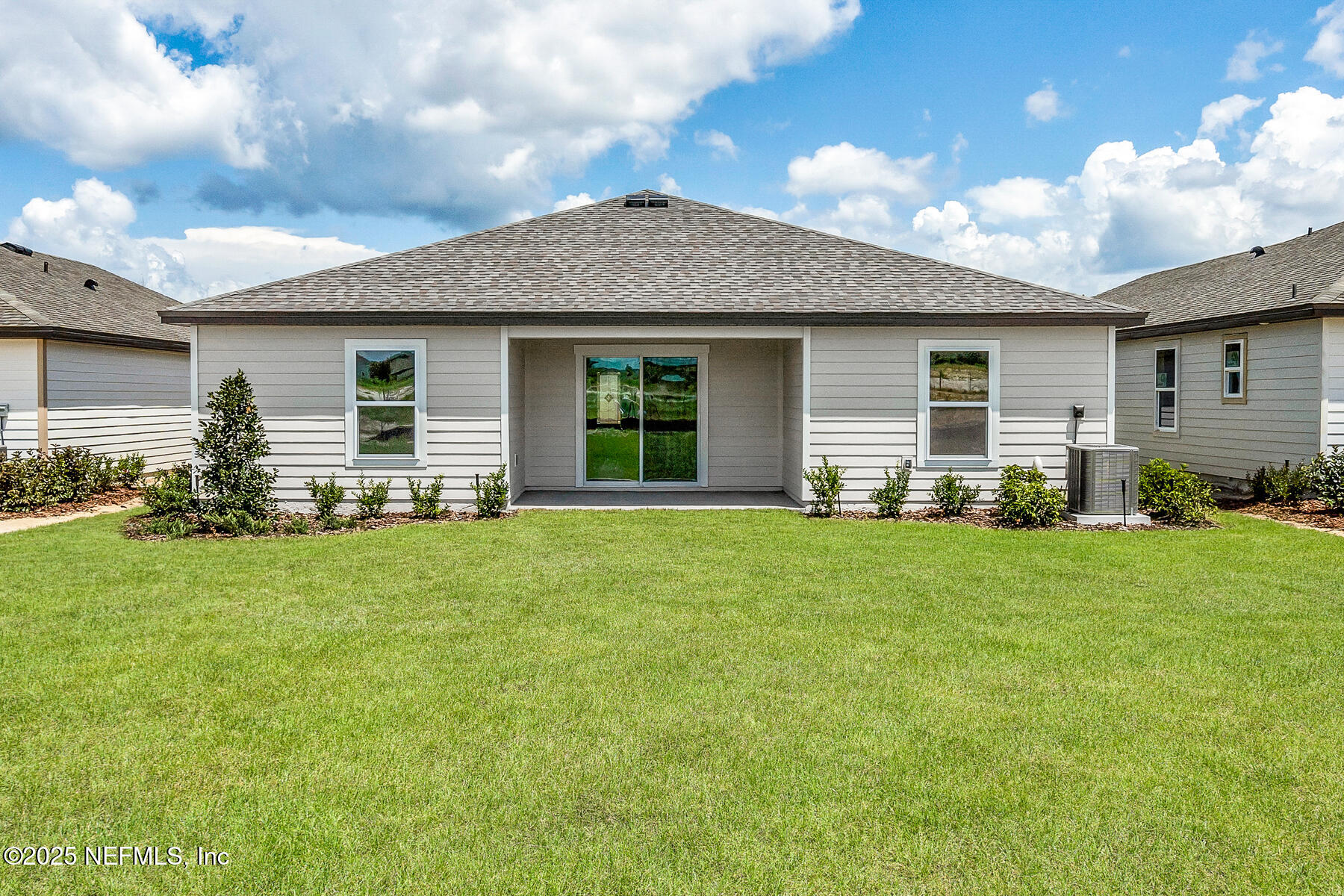 37338 Whisper Way Hilliard, FL 32046 - Photo 13 of 14 a front view of house with yard and outdoor seating