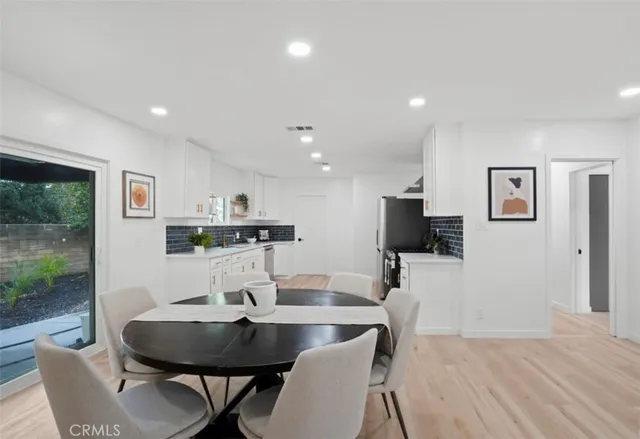a kitchen with granite countertop a sink stainless steel appliances and cabinets