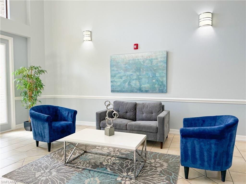 1100 Pine Ridge Road, Unit B405 Naples, FL 34108 - Photo 11 of 43 a living room with furniture and a potted plant