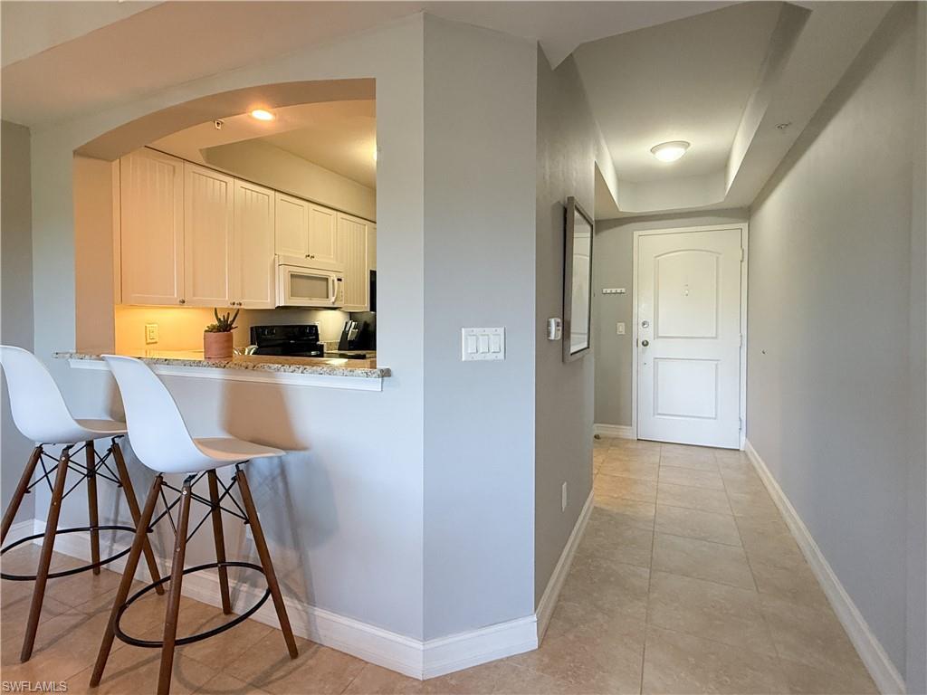 1100 Pine Ridge Road, Unit B405 Naples, FL 34108 - Photo 13 of 43 a view of a kitchen cabinets and dining room
