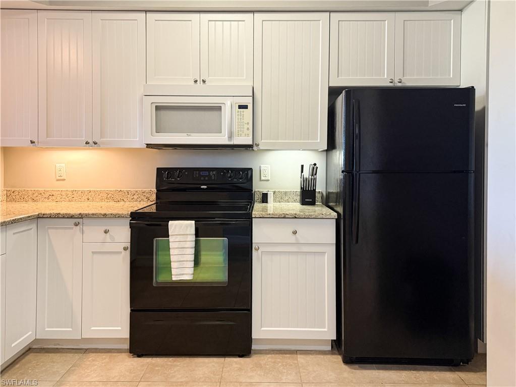 1100 Pine Ridge Road, Unit B405 Naples, FL 34108 - Photo 17 of 43 a kitchen with a refrigerator and a stove
