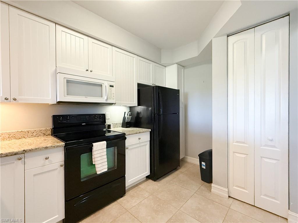 1100 Pine Ridge Road, Unit B405 Naples, FL 34108 - Photo 20 of 43 a kitchen with stainless steel appliances granite countertop a refrigerator and a stove